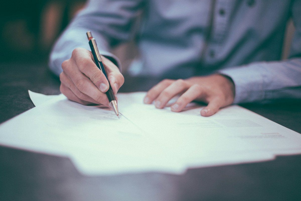 A contract being reviewed and signed